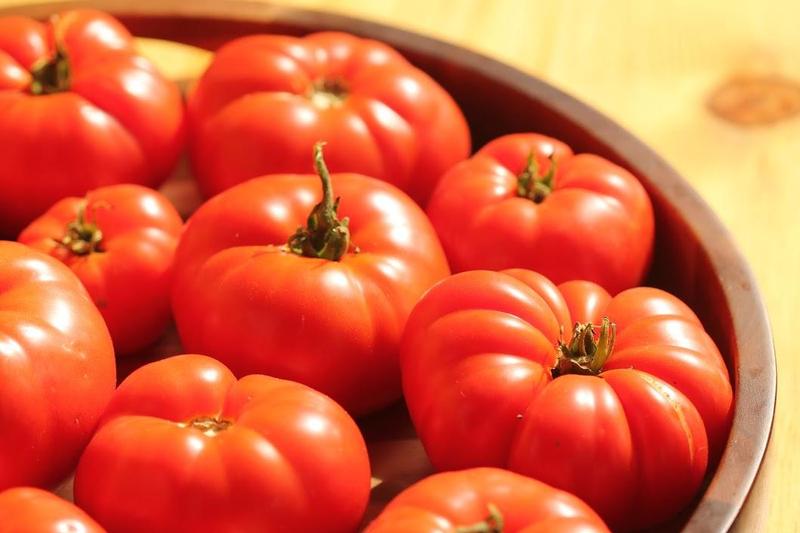 big beautiful red tomatoes in a wooden bowl