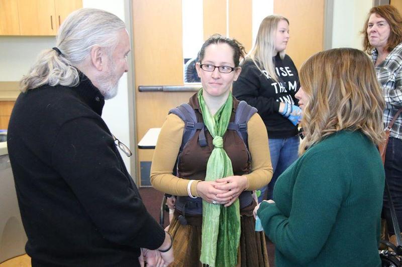 Jacqueline stands talking with two other people at TEDx Couer d'Alene 2020