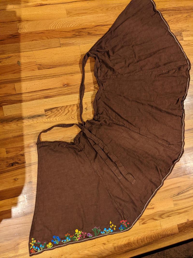 a linen wrap skirt laid out flat on the floor